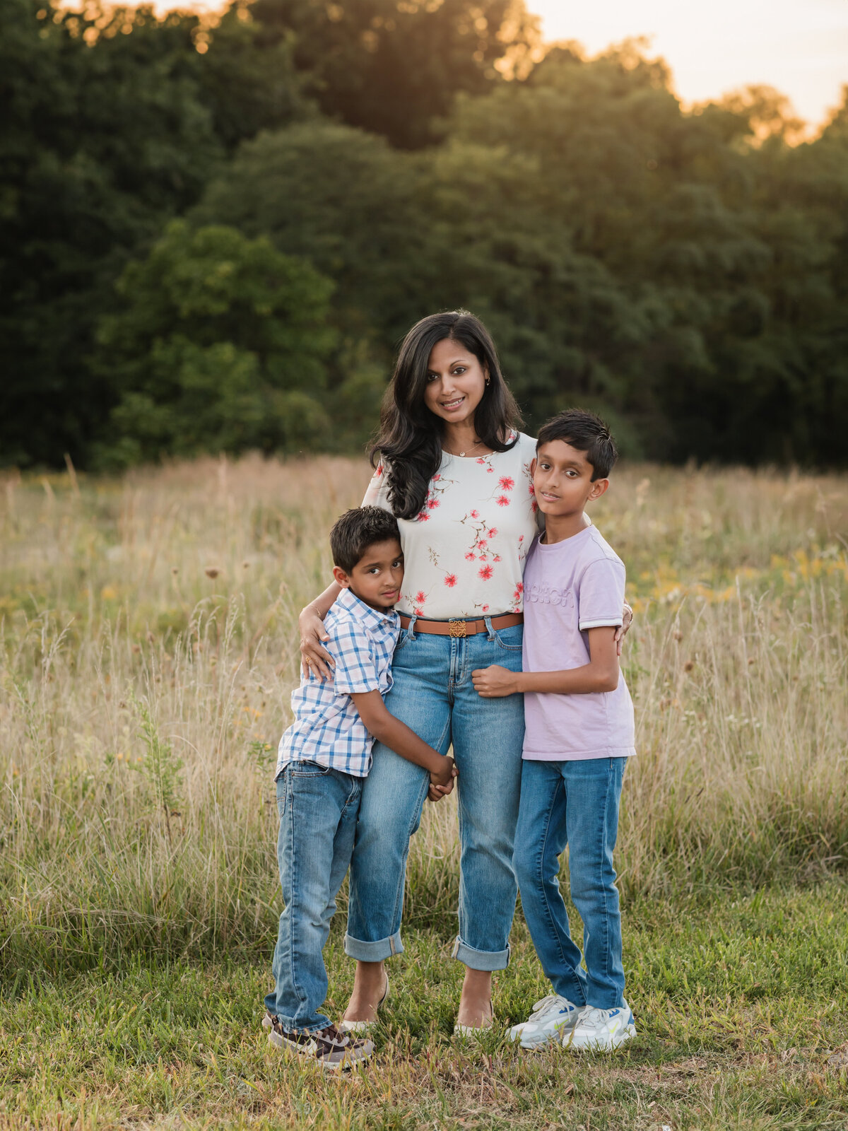 mom and two sons hugging for family photos in field cleveland family photography