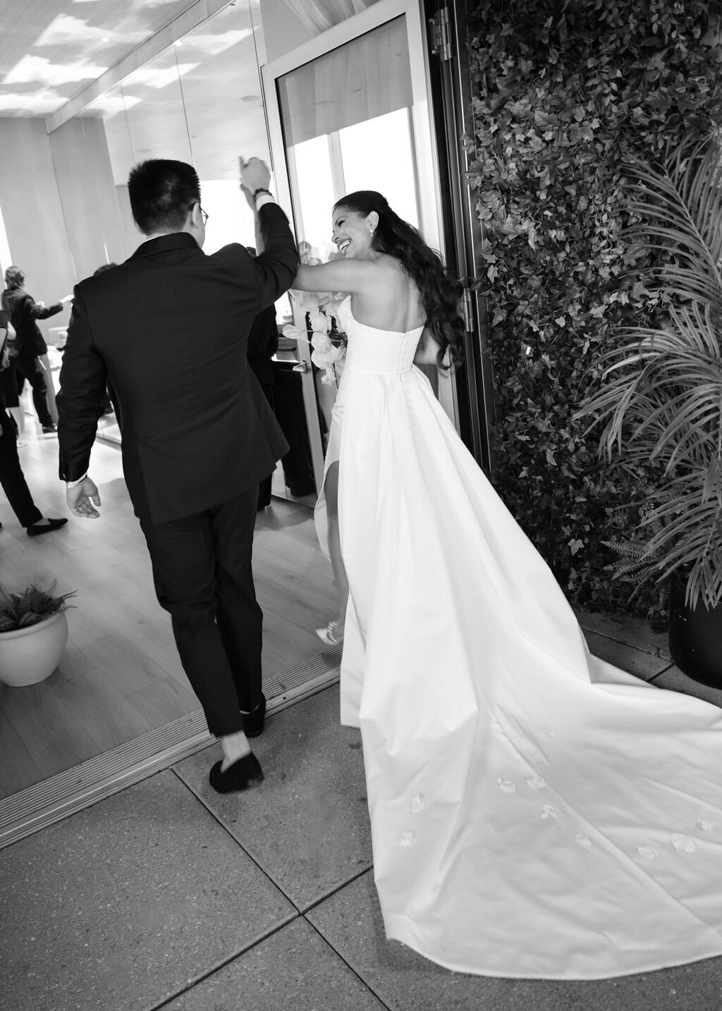 Bride and groom exiting their wedding ceremony at Public Hotel rooftop garden in NYC