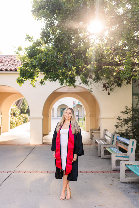 senior-girl-walking-in-robes-san-diego-state