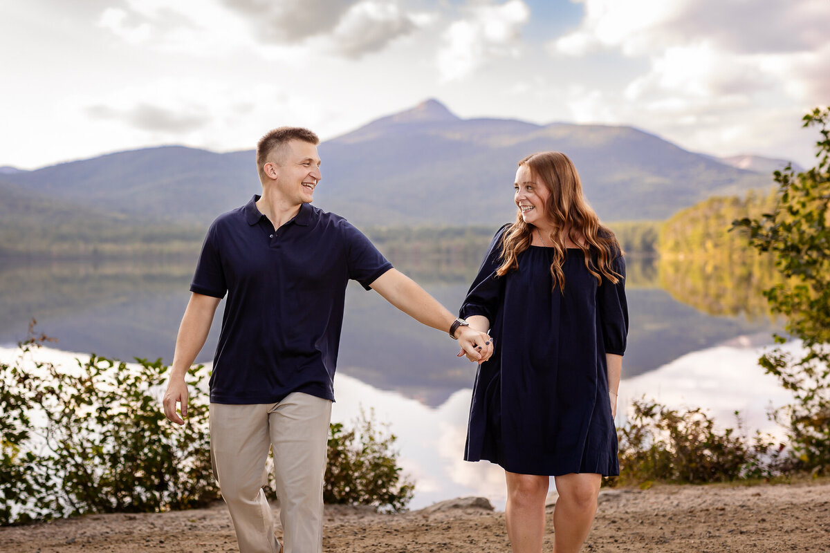 Couple holding hands at Chocorua lake engagement session
