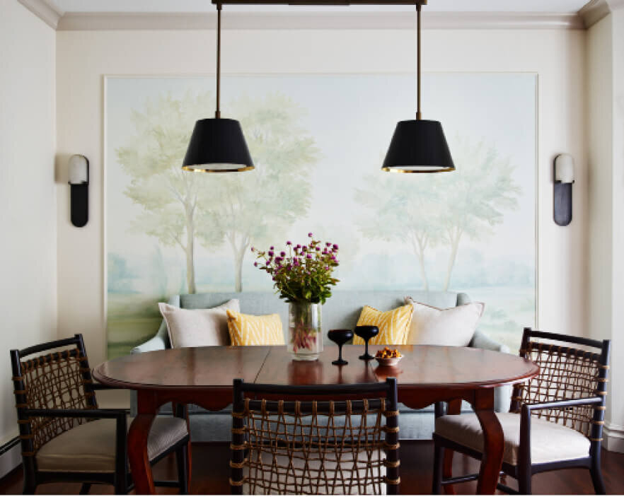 Interior decorator in Milton designed a dining room with a vintage table, woven dining chairs, a custom mural, and Urban Electric light fixtures for a warm, inviting space.