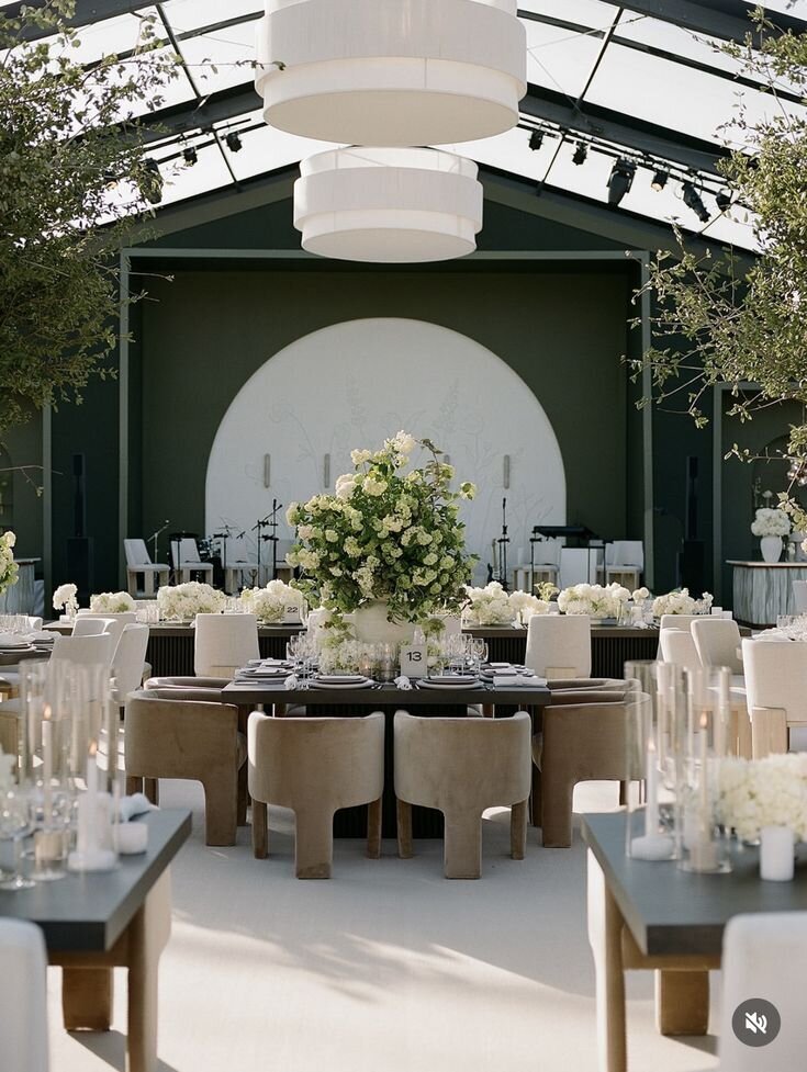 Modern round table wedding reception with curved stage backdrop and neutral tones, a concept for Sycamore Bend Estate