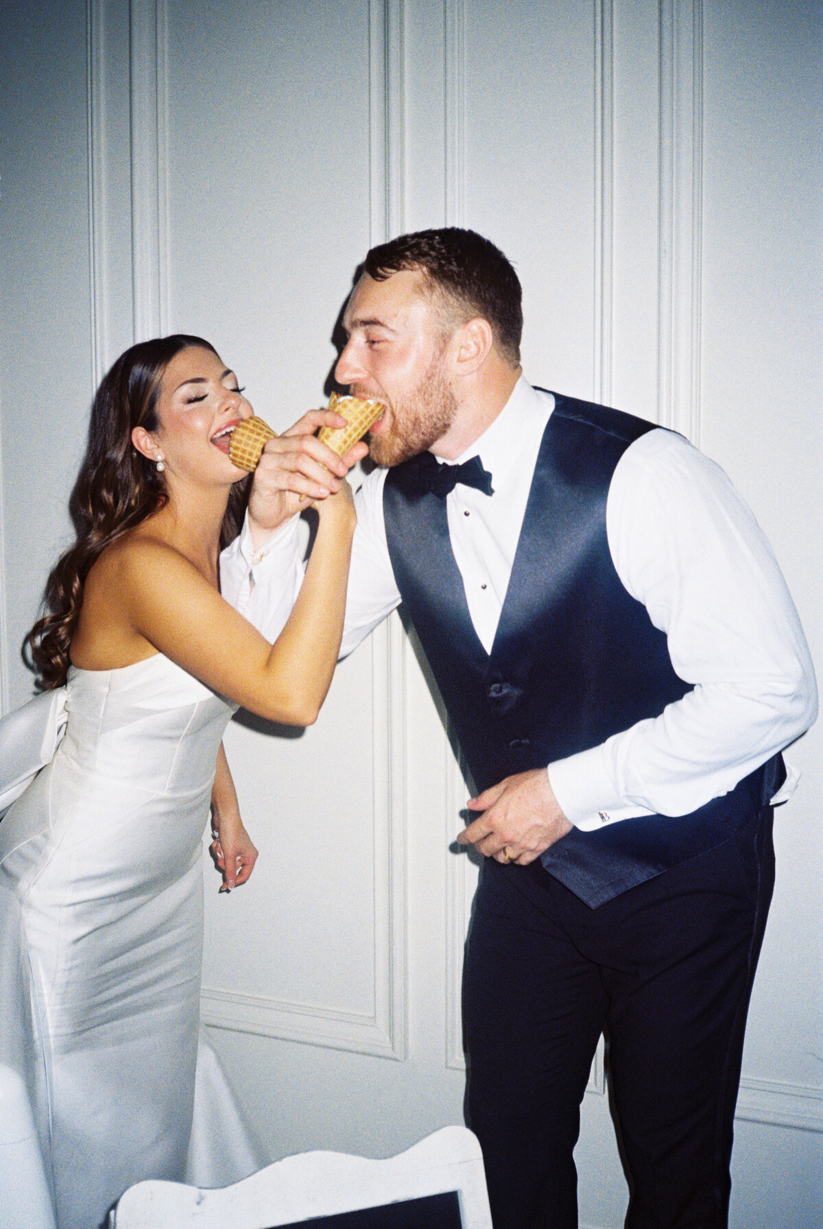 Bride and Groom eating ice cream during wedding reception