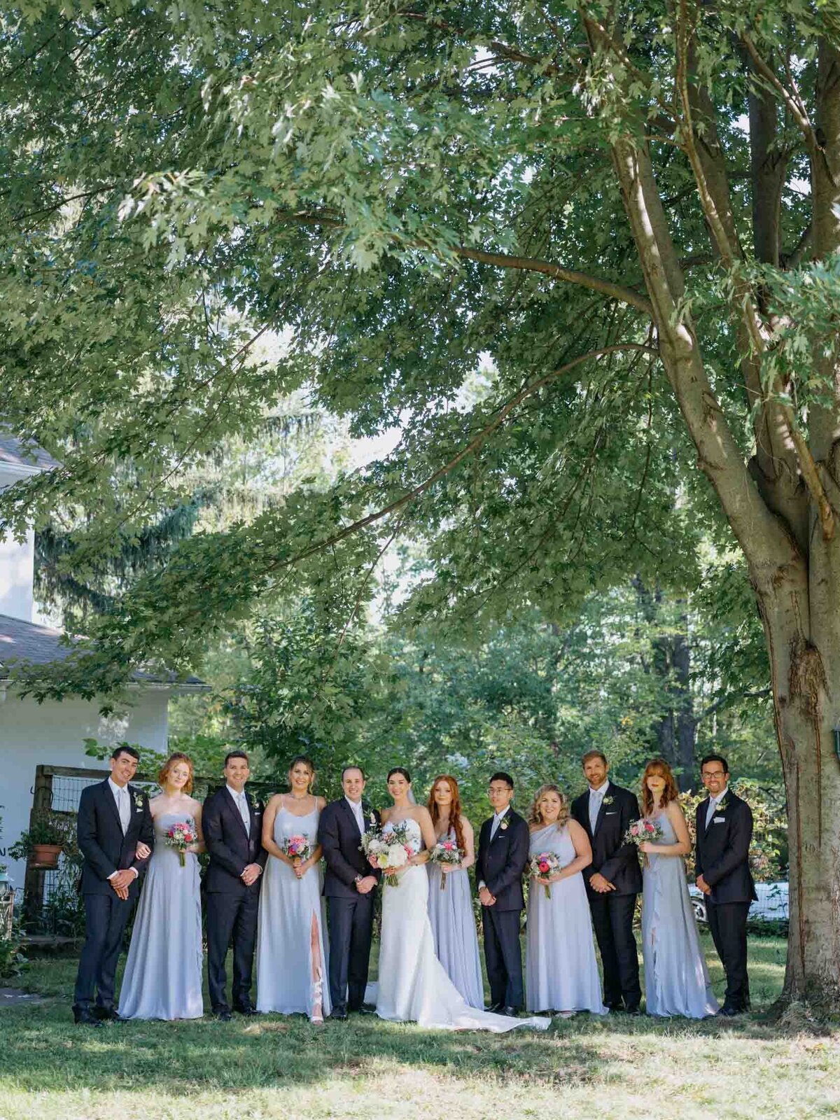 Bridal party with bride and groom at a private residence wedding.