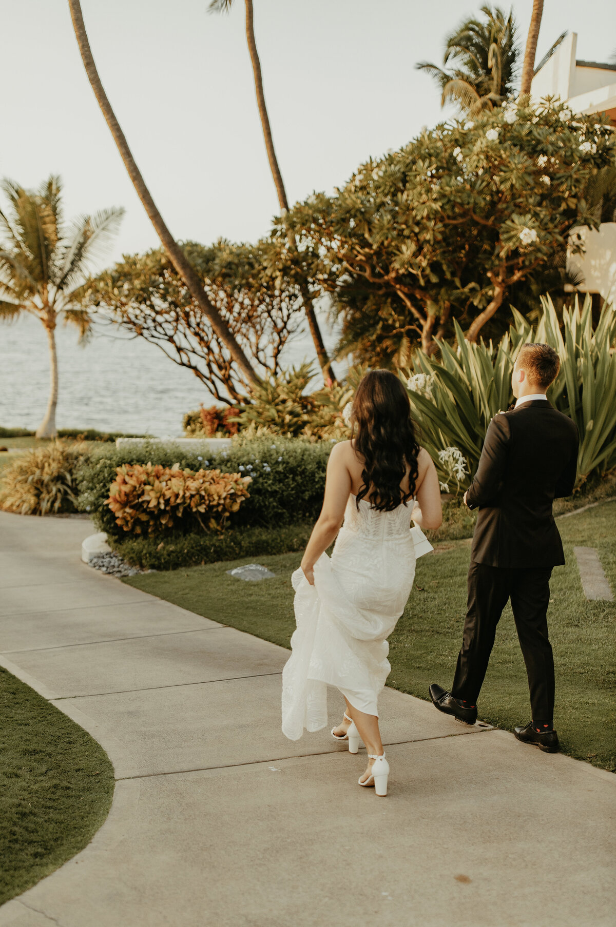 Wedding Photographer & Videographer, bride and groom walking down pathway