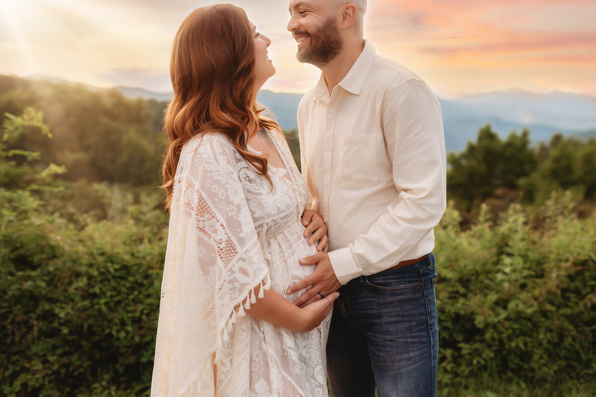 Expectant parents pose for Maternity Photos on the Blue Ridge Parkway in Asheville, NC.