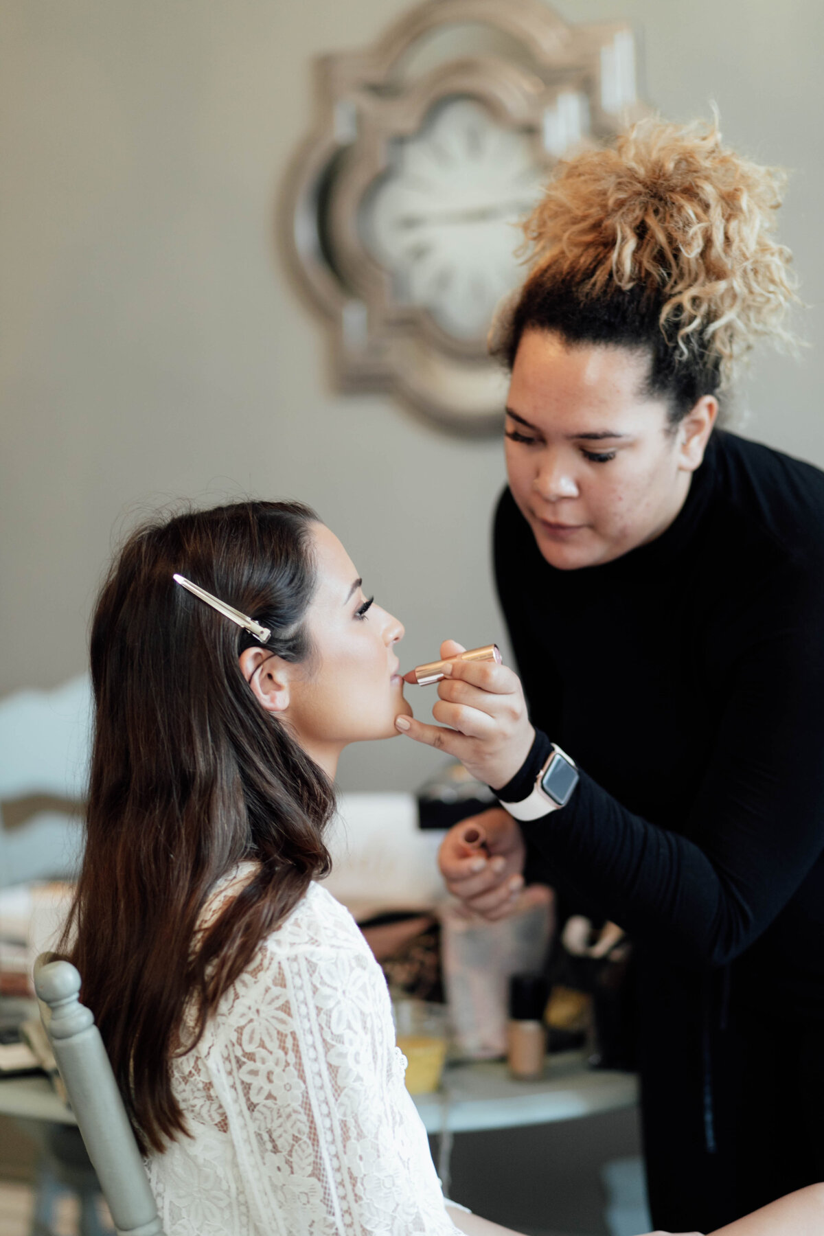Bride putting on lipstick. 