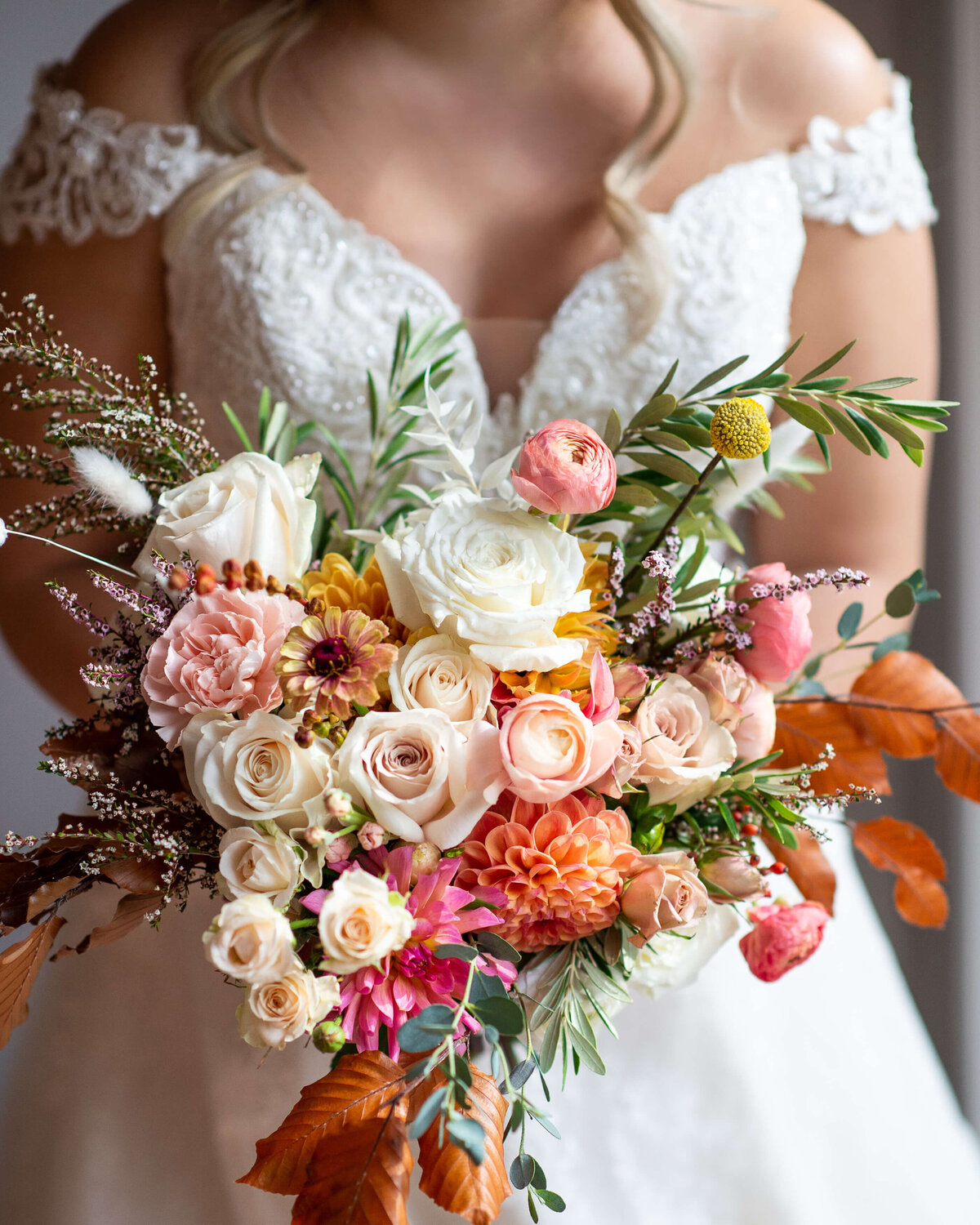 a closeup photo of a beautiful fall bride bouquet in orange, blush and white.  Captured by Ottawa wedding photographer JEMMAN Photography