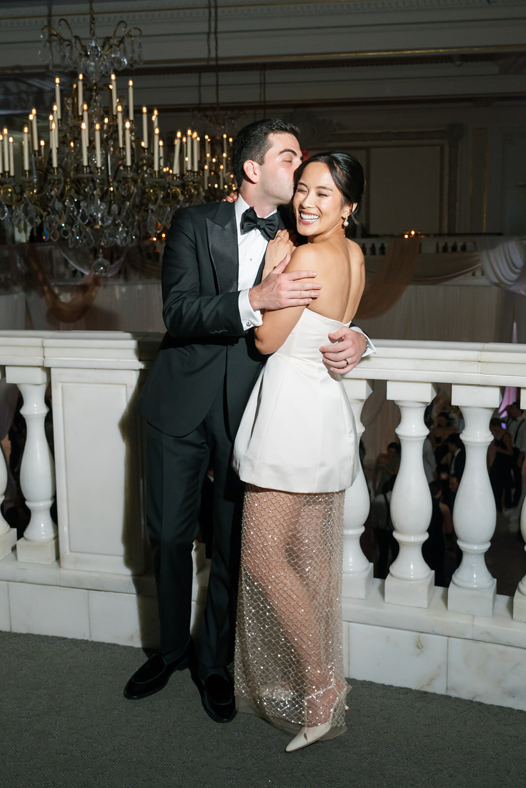 Couple in second look posing for photos at the National Museum of Women in the Arts. 