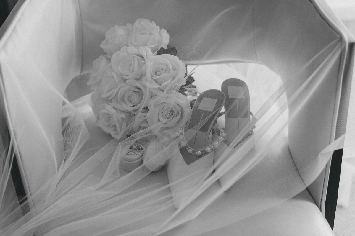 wedding bouquet and shoes under bridal veil