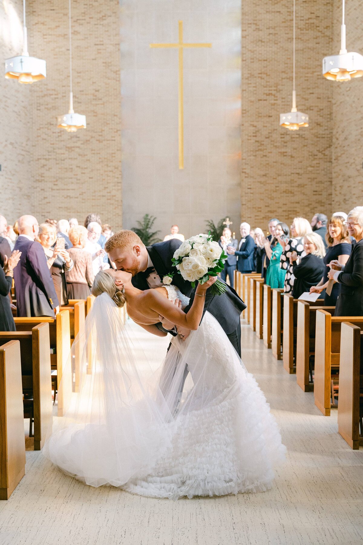 Bride and Groom's first kiss during their wedding ceremony at St Joseph Chapel at Holy Cross College in South Bend, Indiana