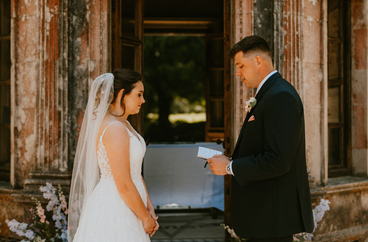Groom reading vows to bride