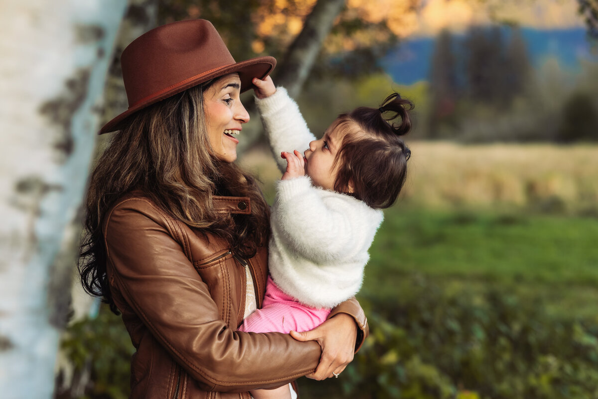 toddler-playing-with-moms-hat
