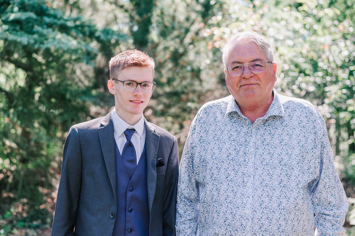 Standing with his dad. 