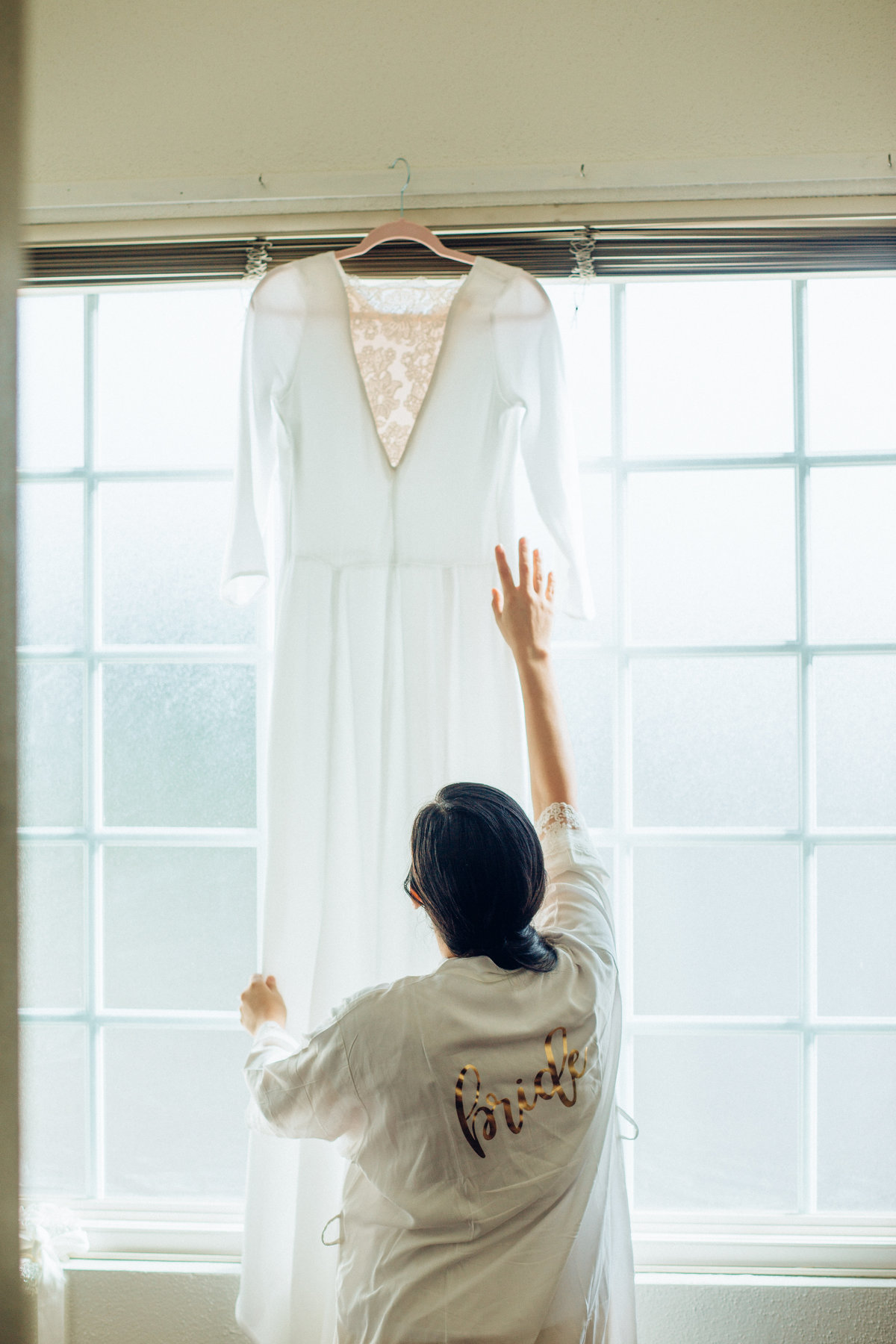 Wedding Photograph Of Woman  Fixing White Dress Los Angeles