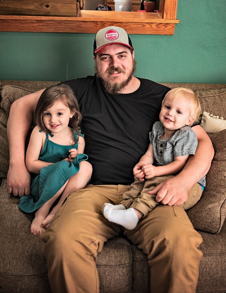 dad holding two kids