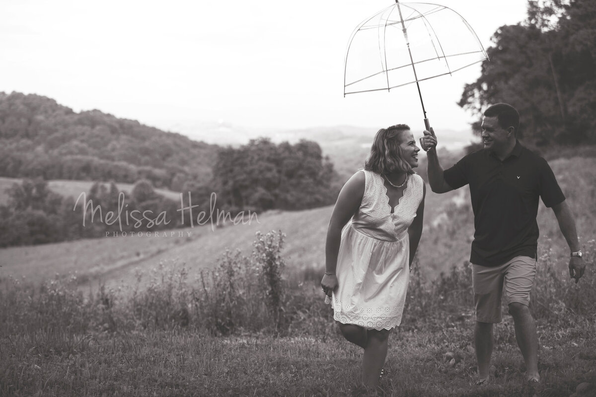 engaged couple walking in the rain