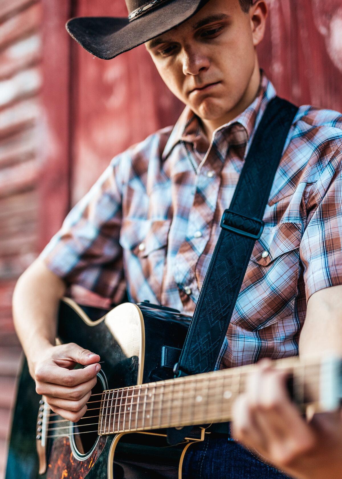 Guitar being played at country themed senior photo session by lisa smith photography