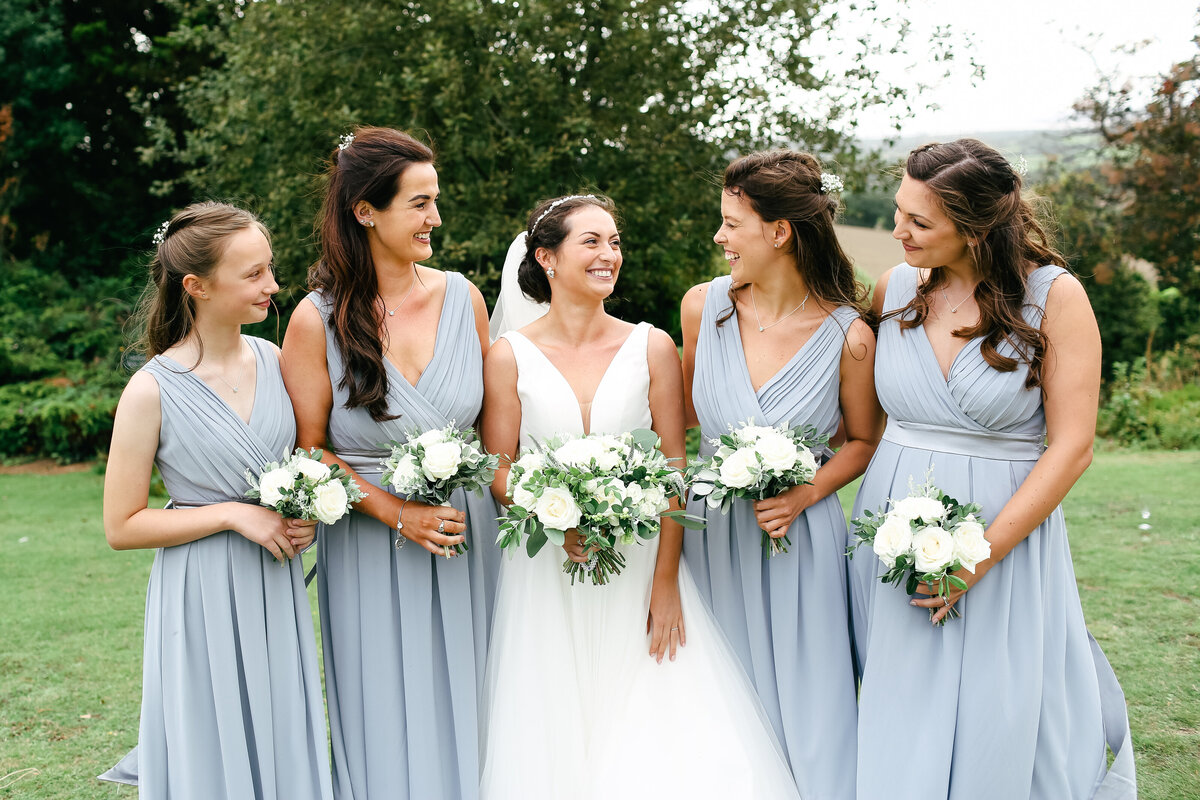 bride-and-bridesmaids-smiling-at-luxury-wedding-in-surrey-hills