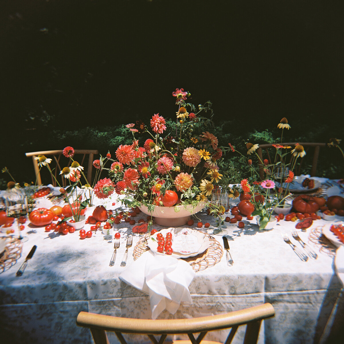 A 35mm film image of a table setting with reds and oranges for summer.