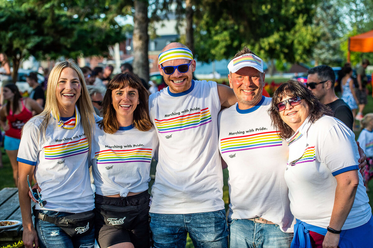 the planners of the Tweed Canopy Growth pride parade with their arms around each other and smiling.  Captured by Ottawa Event Photographer JEMMAN Photography COMMERCIAL