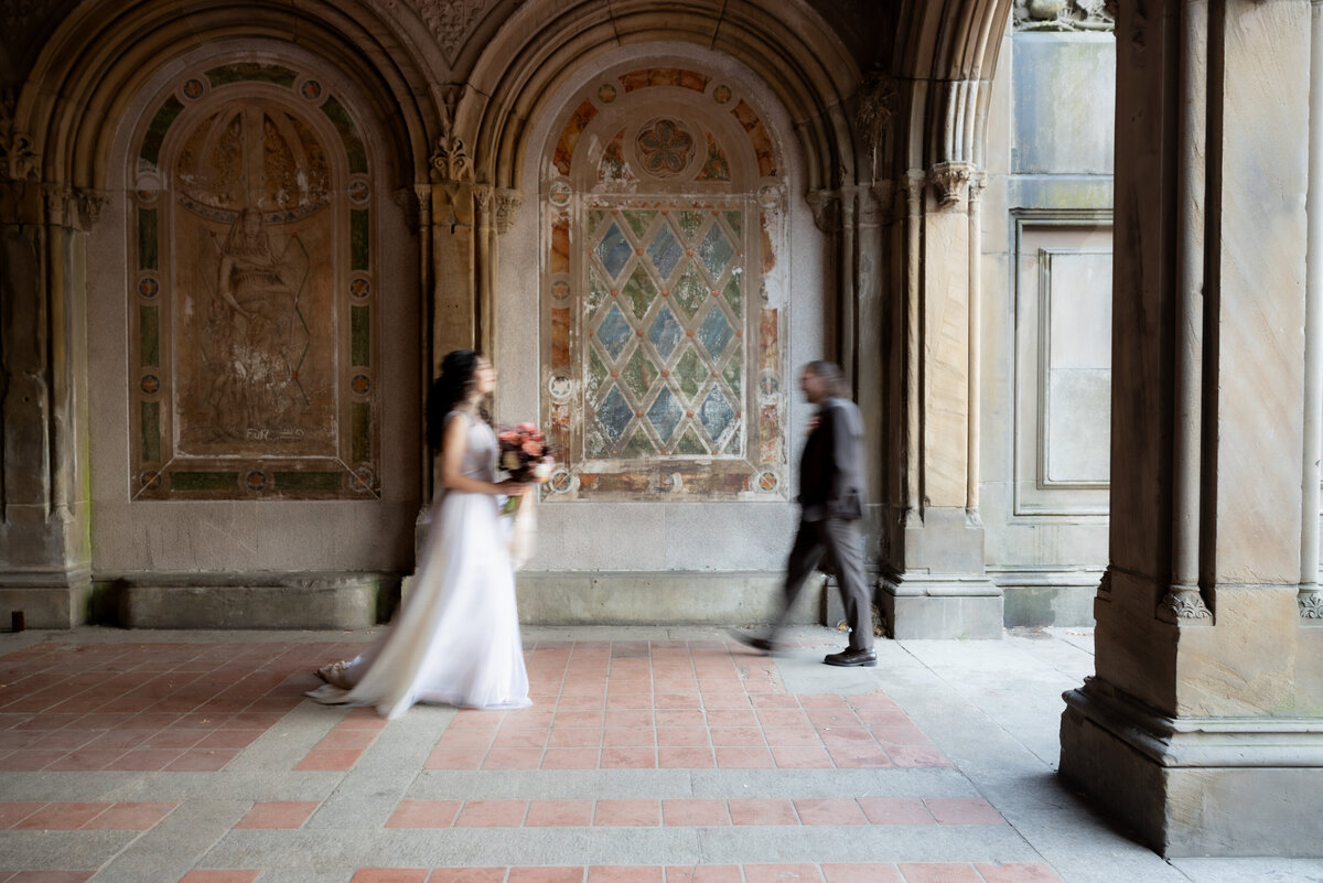 The couple sharing a tender moment beneath Central Park’s beautiful stone arches.