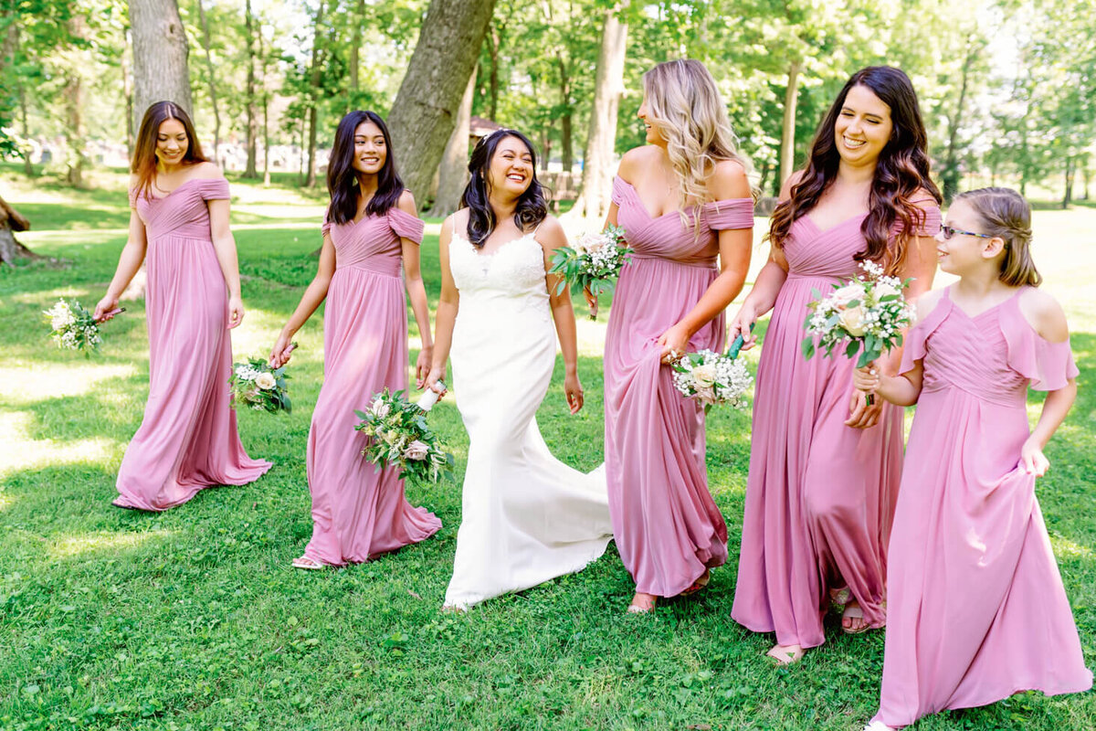 Bridemaids in pink  enjoying a walk in the park with their bride.