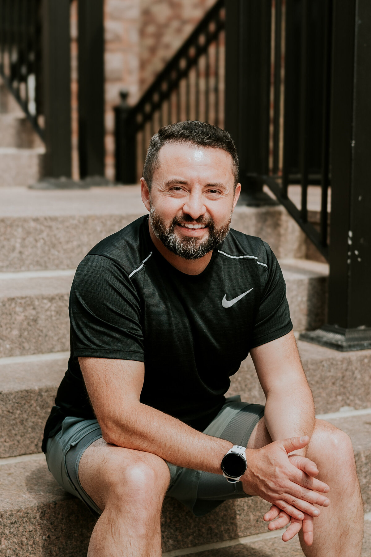 A modern online dating portrait of a man standing against an urban backdrop in Minneapolis, styled for dating apps like Hinge and Bumble.