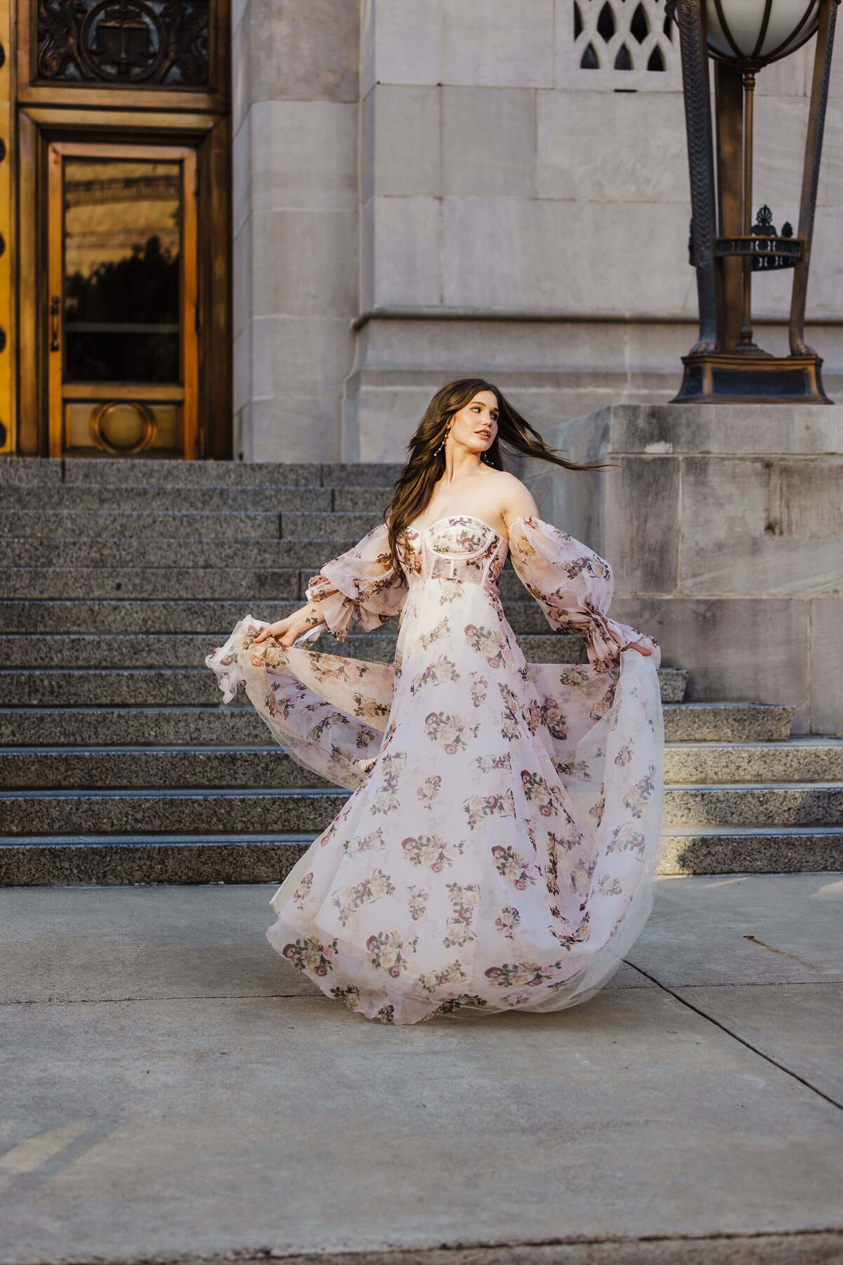 bride in nontraditional floral bridal gown spinning in front of Shreveport elopement venue
