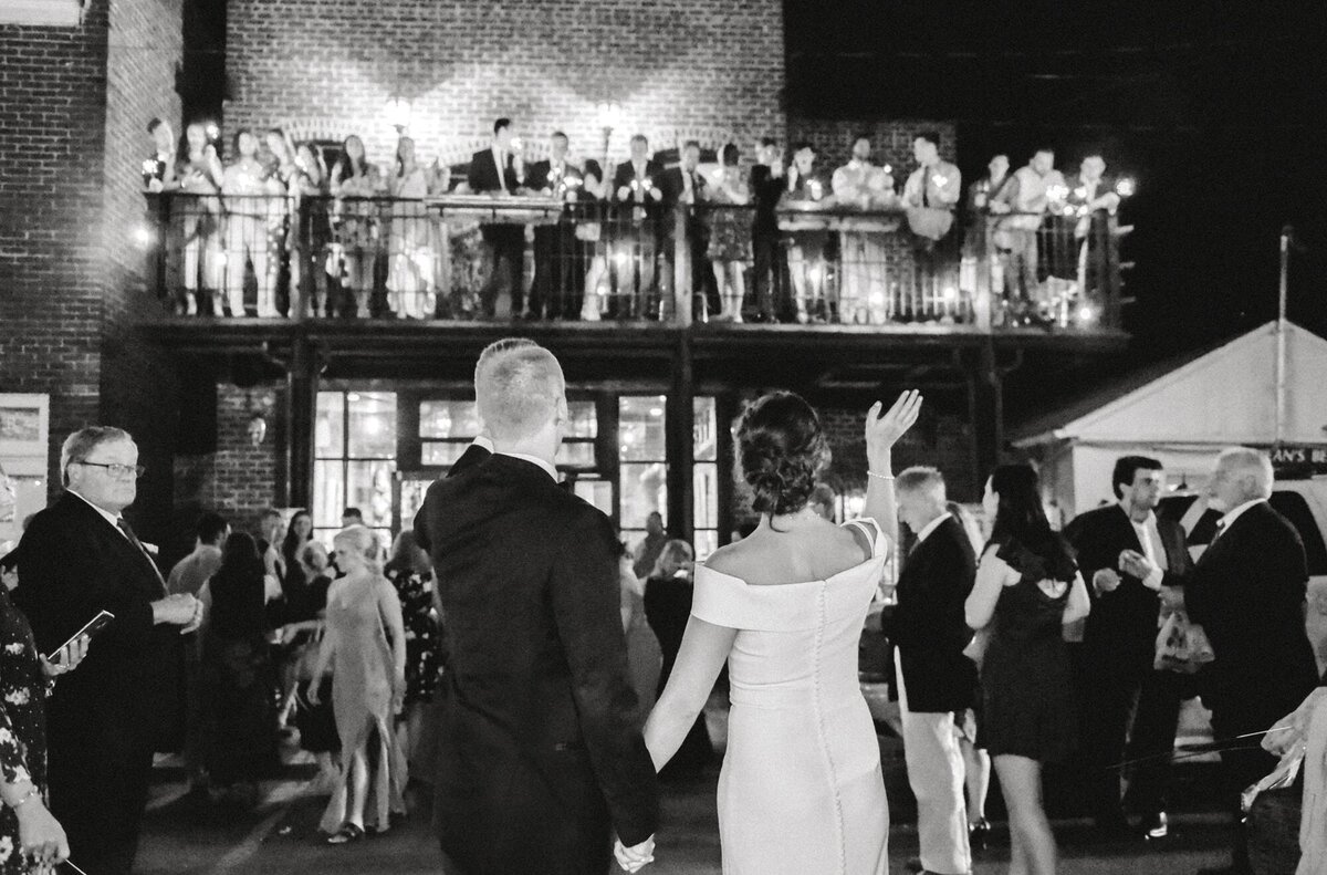 Bride and groom wave goodbye to guests after reception at the Local Charlottesville wedding