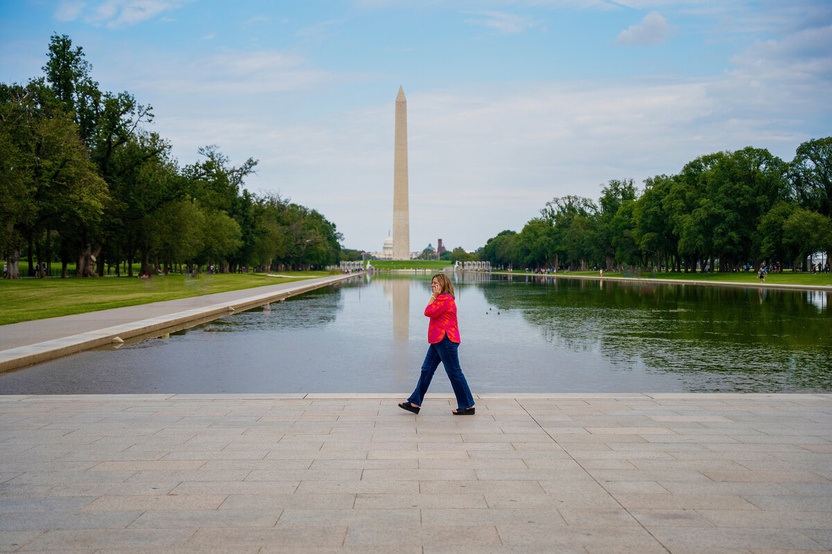 Toni Slye Miller taking a phone call in front of the Washington Monument in Washington, DC.