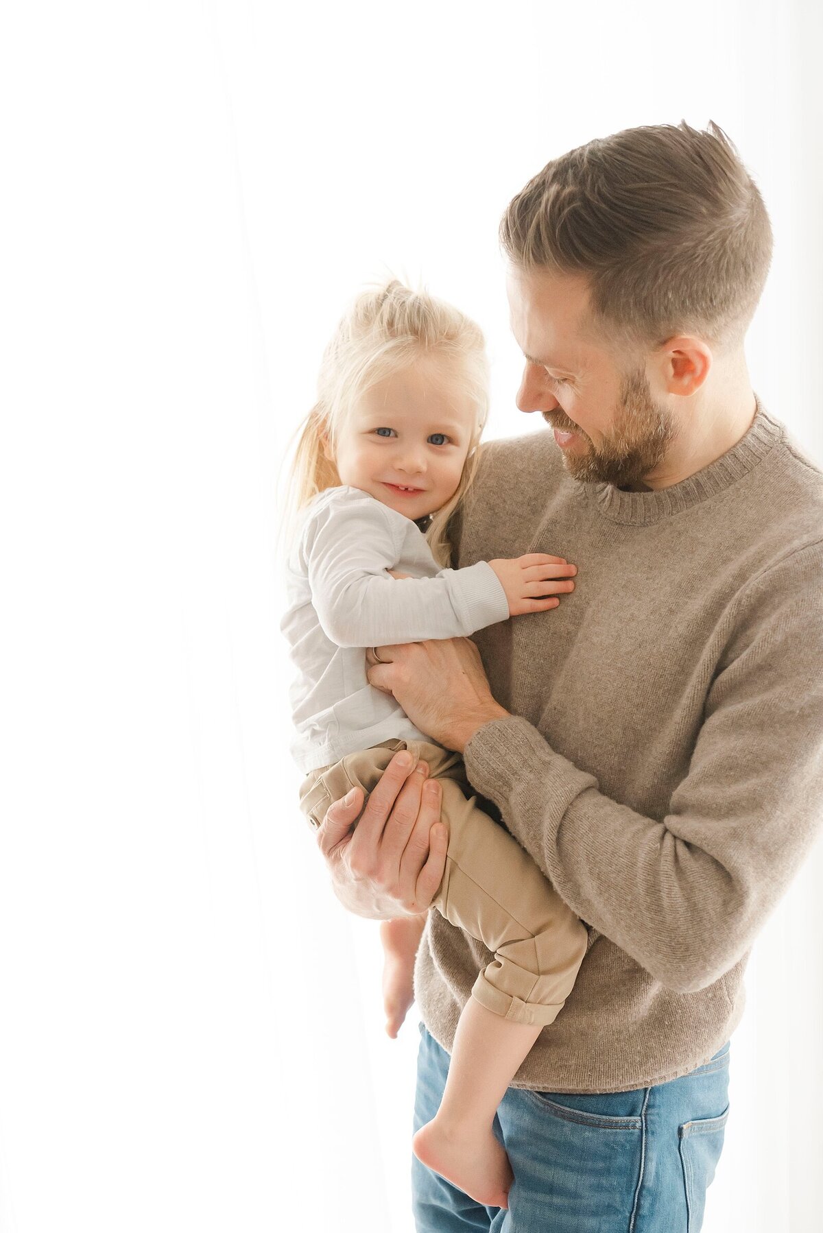 father holding baby taken by family photographer boston ma​