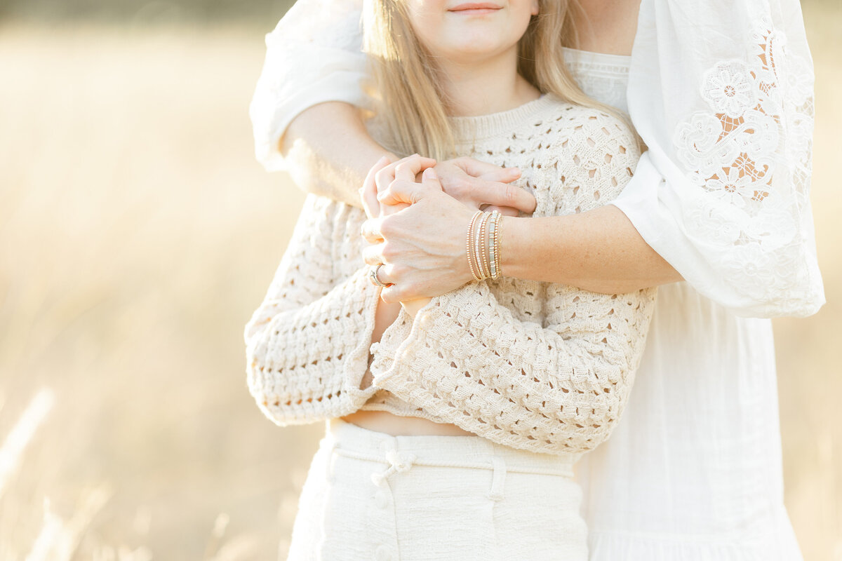 Close up photo of a mother holding her daughter for family photos in a DFW park.