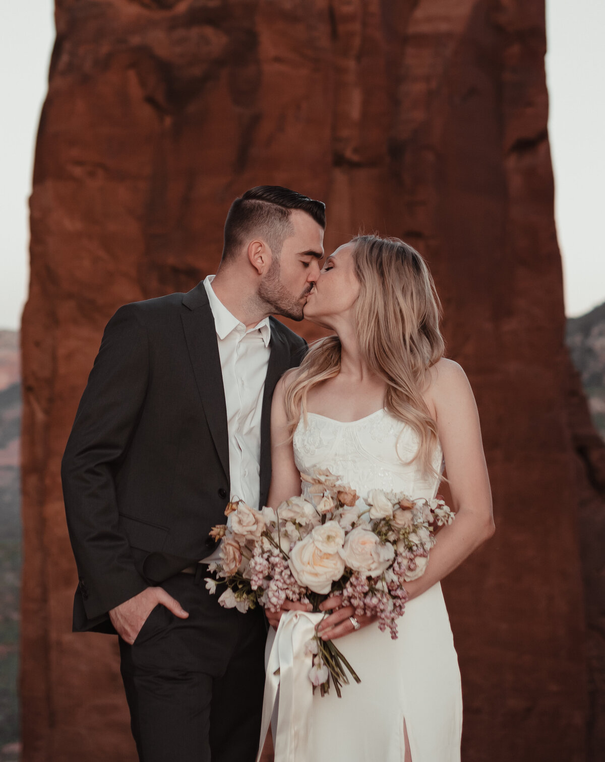 Couple holding hands during Sedona elopement at Cathedral Rock taken by Kollar Photography