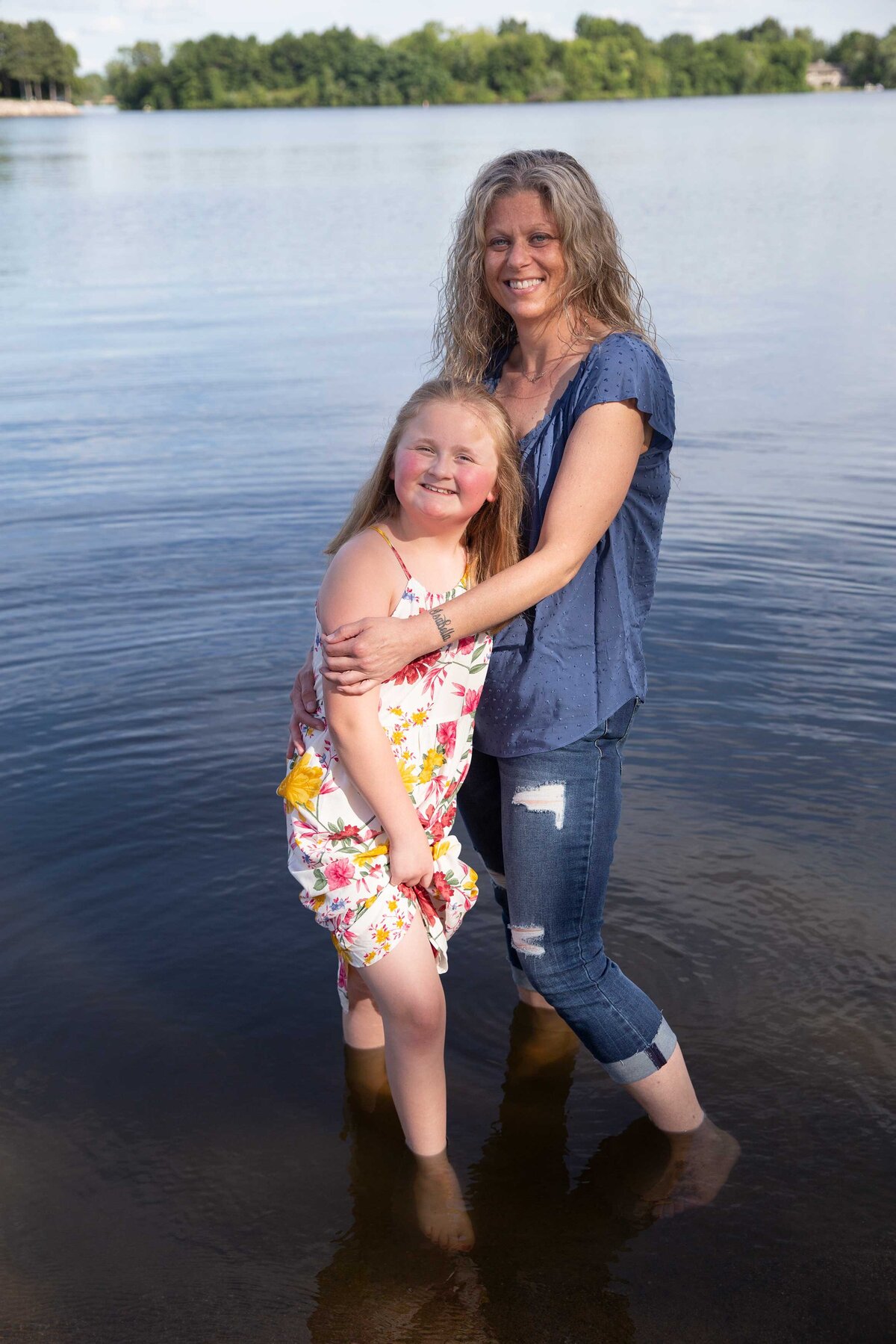 family portrait of mom and daughter at a lake