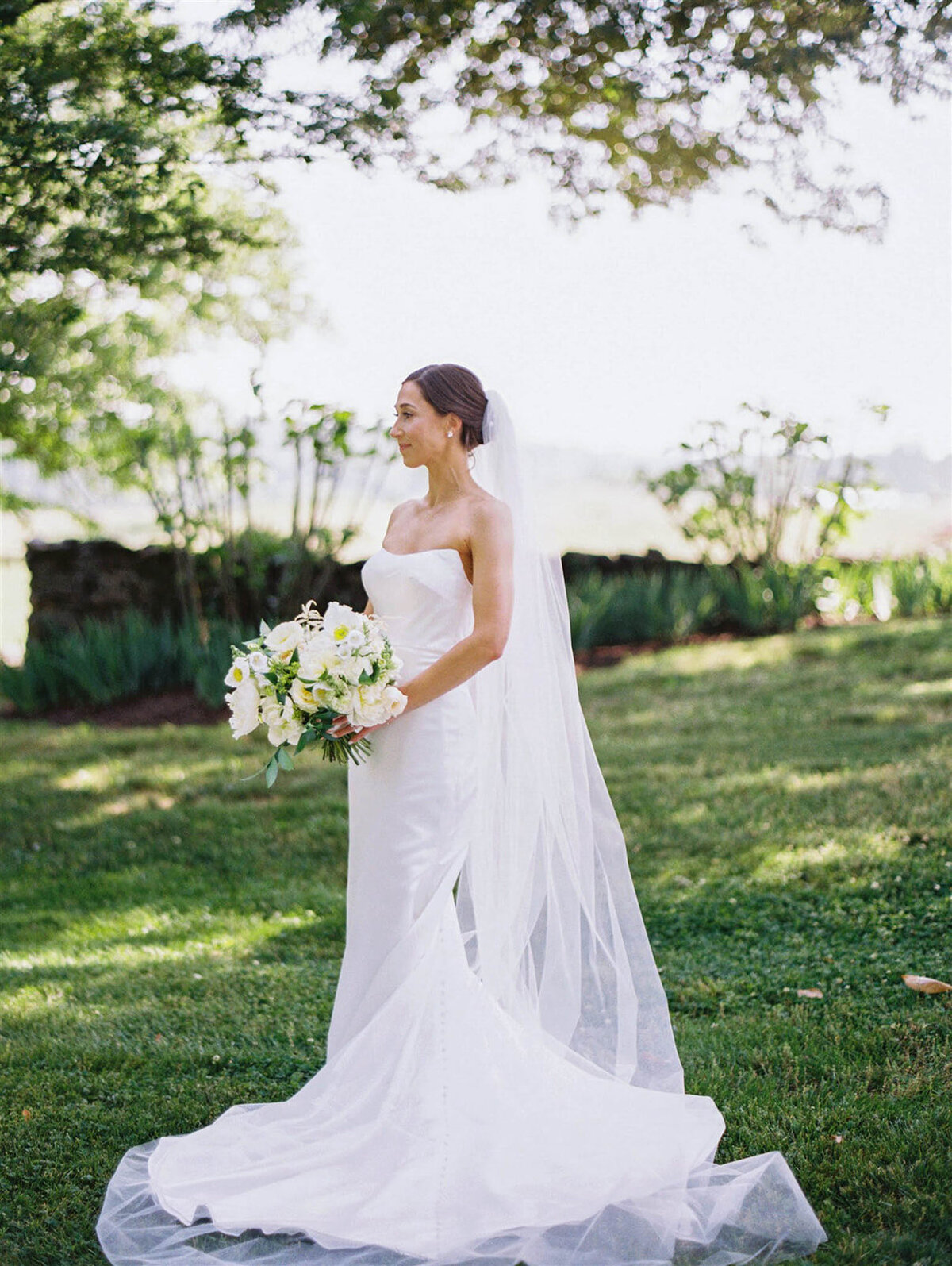 A brides portrait holding her flowers on the garden at goodstone inn