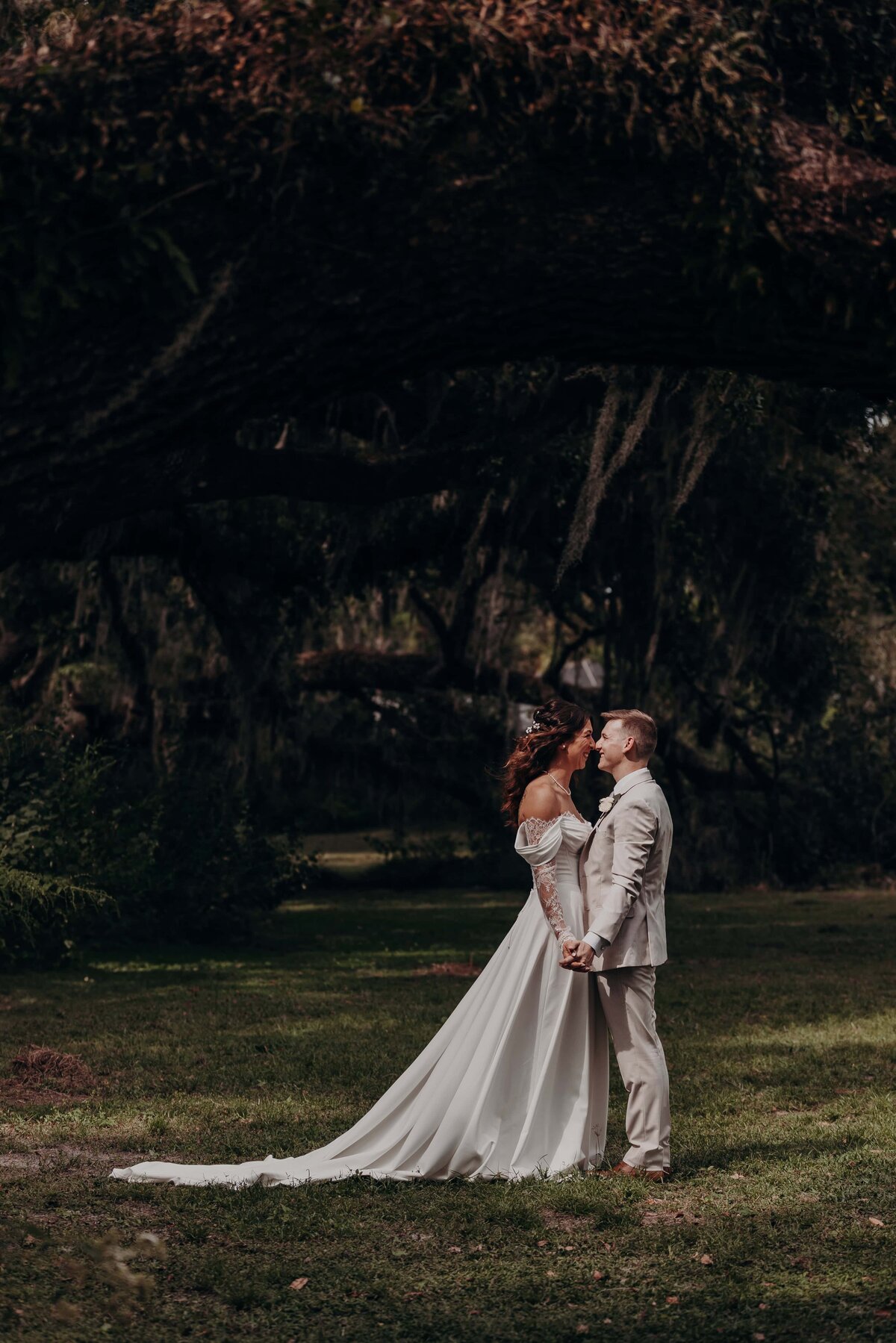 Bride and groom portraits under the trees at the Seffner flower barn, Ever After Farms, a Florida wedding venue.