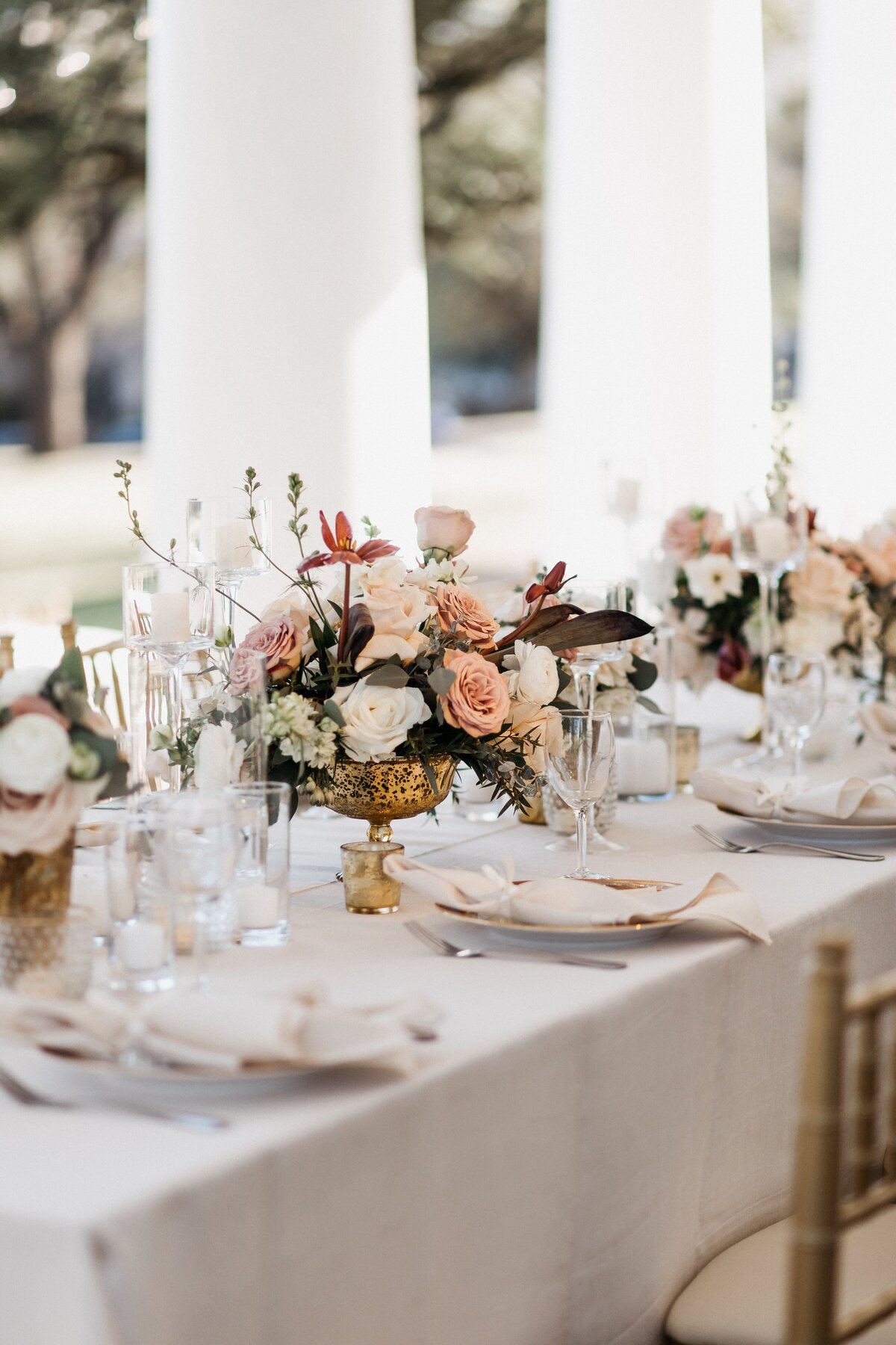 beautiful table setting with light pink and burgundy flowers