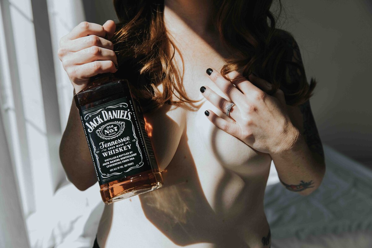 Using a bottle of Jack Daniels as a prop during shoot