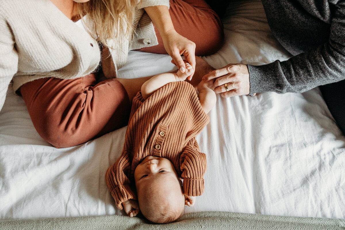 Baby on bed with parents