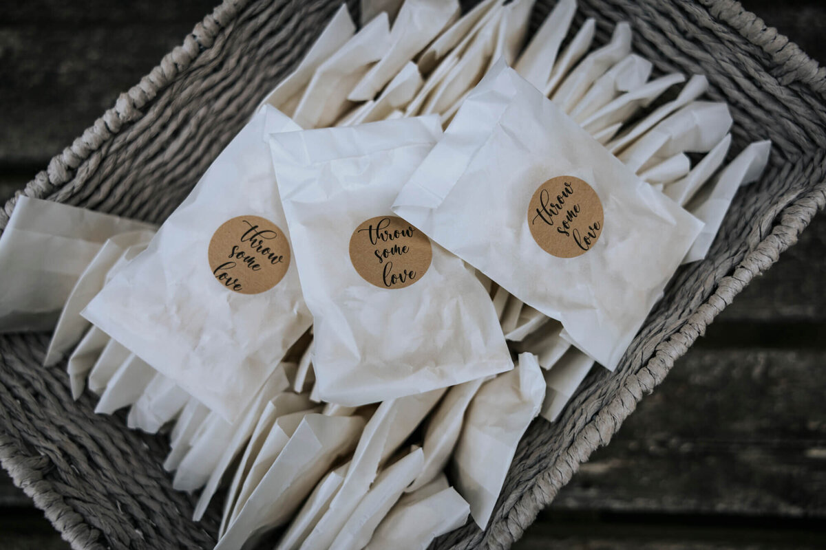 A basket filled with confetti in paper packets