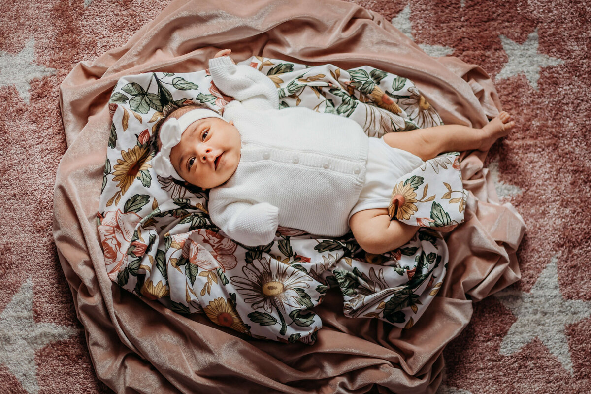 baby girl on blanket nest