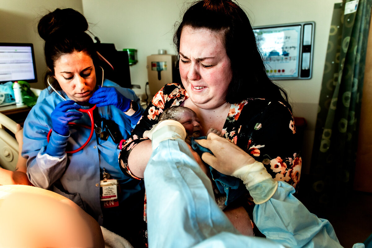 A surrogate gives birth and the mom-to-be holds the baby for the first time and cries