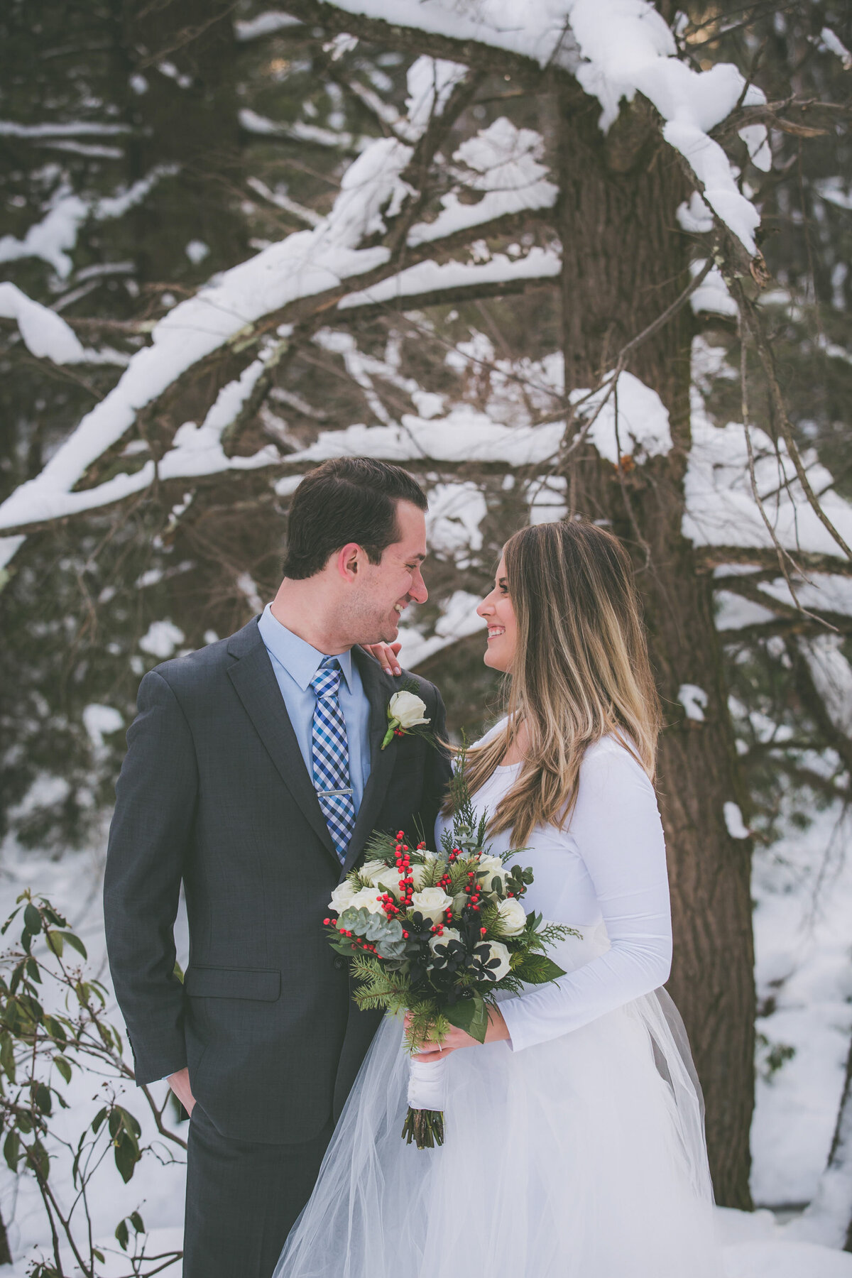A couple looks at each other and smiles during their hiking elopement.