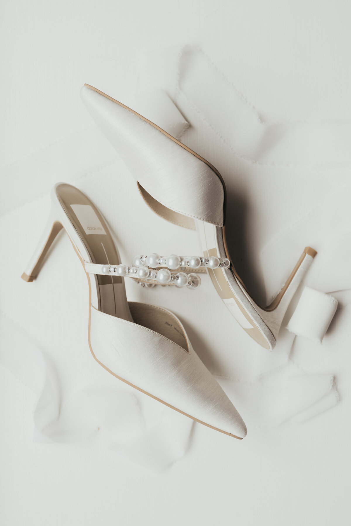These white shoes are adorned with white pearls making them the perfect shoes for a beautiful wedding day.