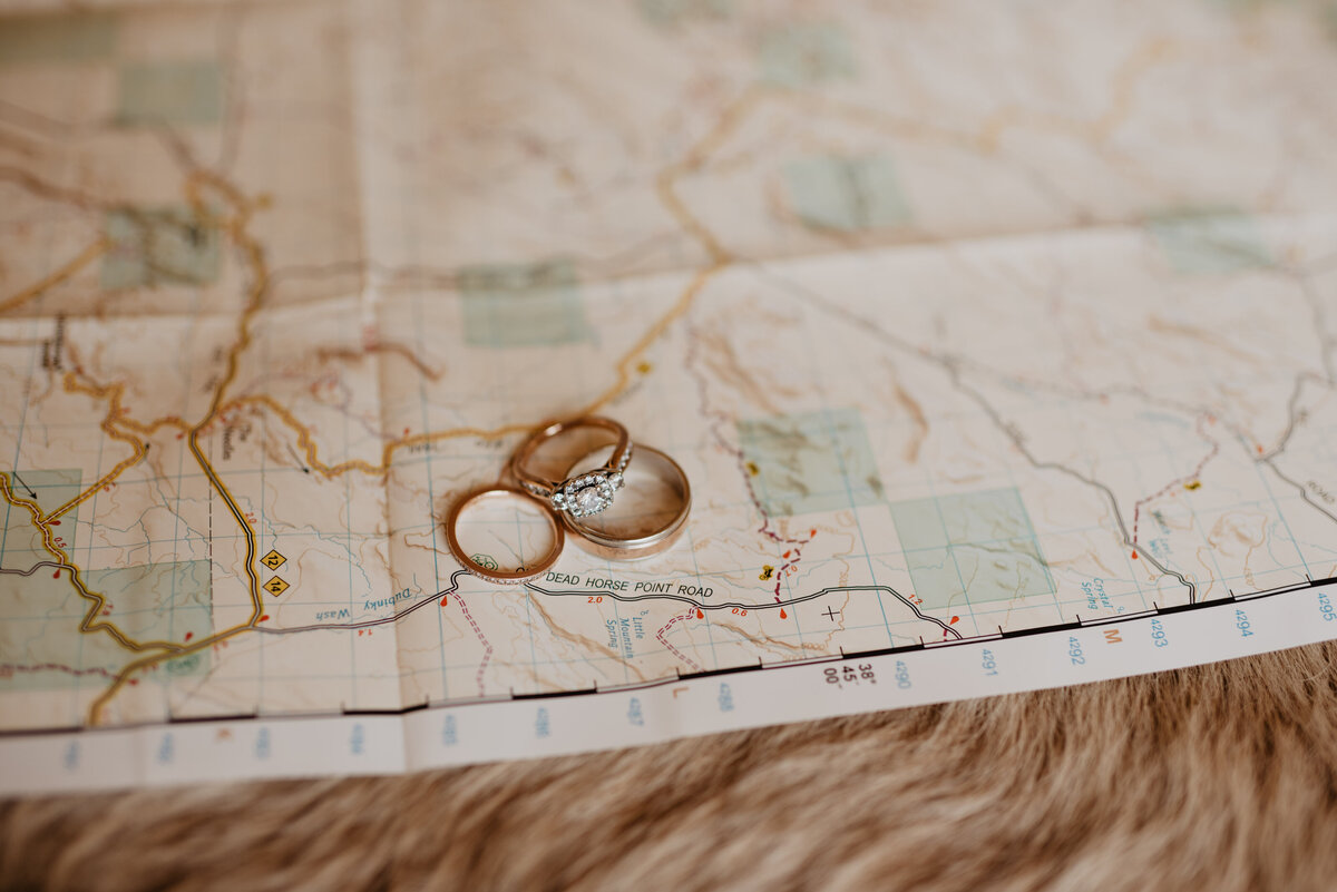 Utah Elopement Photographer captures wedding rings on map