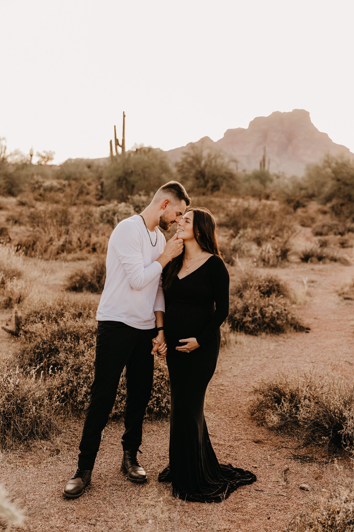 mom and dad posing at sunset forphoenix maternity session