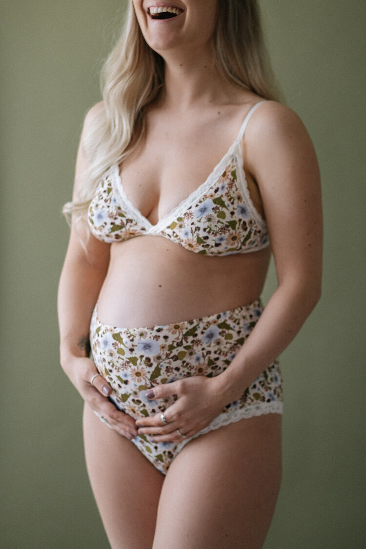 Pregant woman laughs during a maternity studio shoot