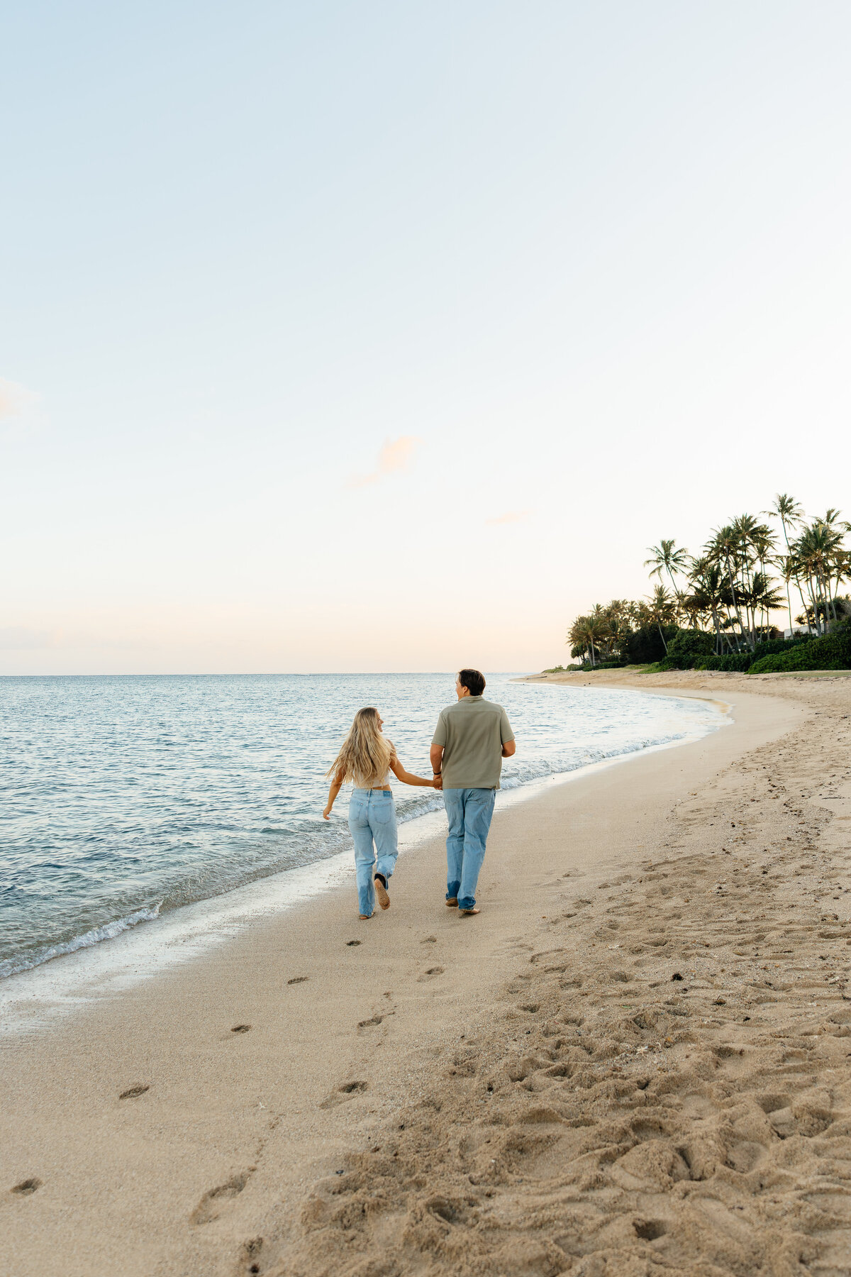 Candid couples photoshoot during sunset at a beach in Honolulu