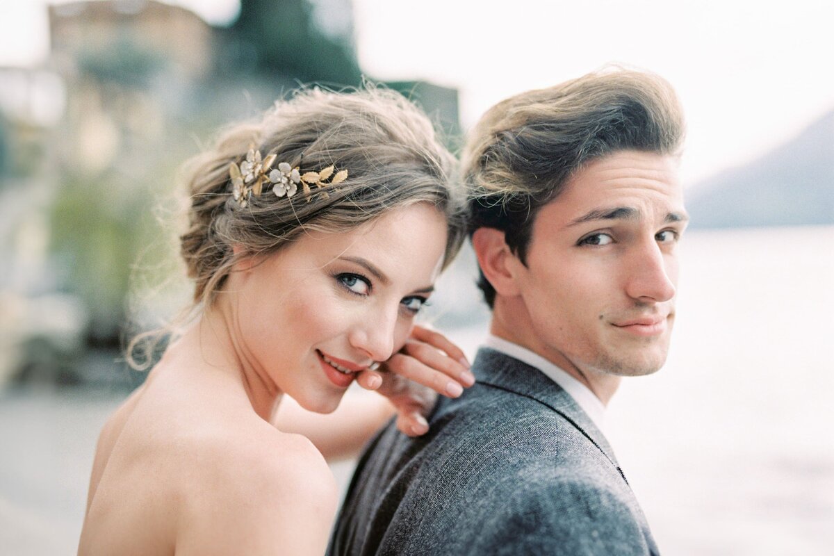 bride-hugs-groom-shoulder-from-portrait